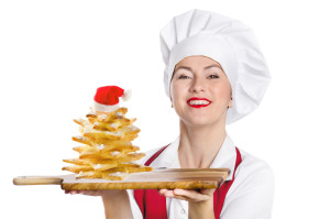 Portrait of smiling Christmas woman chef with sweet cookies tree  isolated on a white background