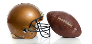 A retro football helmet and football on a white background